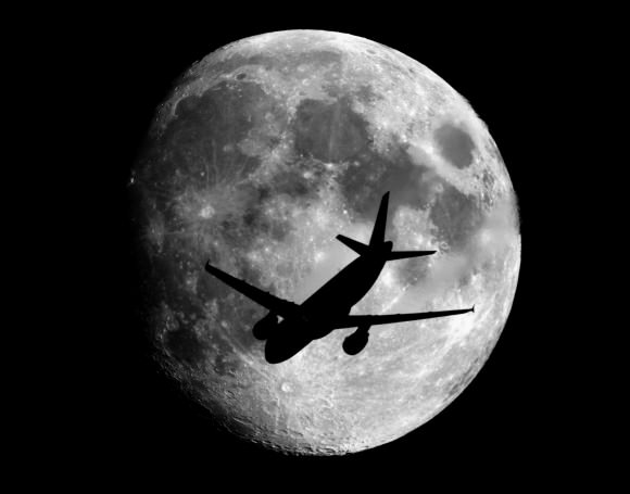An airplane at about 2,400 meters above the ground passes in front of the Moon on its way to landing at the Charles de Gaulle Airport in Paris, France. Taken from about 70 km from Paris. Credit and copyright: Sebastien Lebrigand.