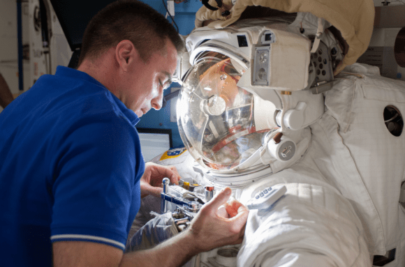 Astronaut Chris Cassidy works with Luca Parmitano's spacesuit, which had a water leak on July 16, 2013. Credit: NASA