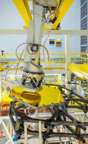 A robotic arm positions one of James Webb's 18 mirrors. Image: NASA/Chris Gunn