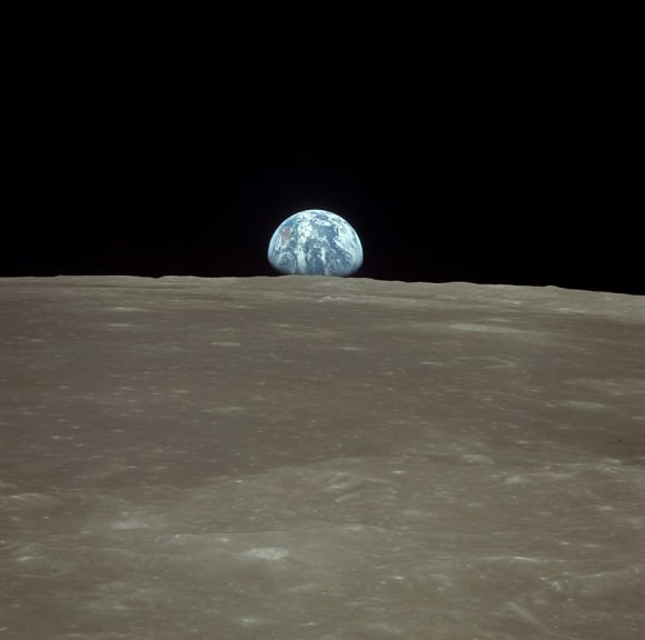 moon surface earth. Earth rise over lunar surface.