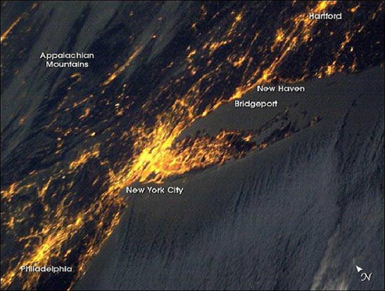 new york city at night from space. New York City has a population