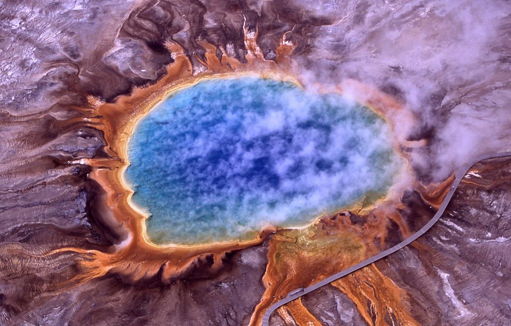The Grand Prismatic Spring in Yellowstone National Park. Microbial mats of extremophiles create the orange colors around the edge. Image Credit: By Jim Peaco, National Park Service - http://www.nps.gov/features/yell/slidefile/thermalfeatures/hotspringsterraces/midwaylower/Images/17708.jpgtransferred from the English Wikipedia, original upload 1 April 2004 by ChrisO, Public Domain, https://commons.wikimedia.org/w/index.php?curid=326389
