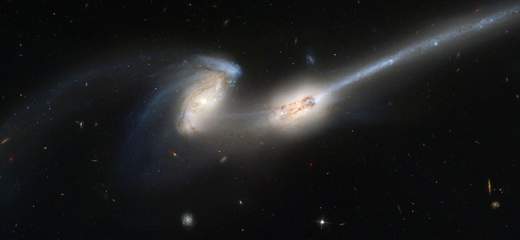 The Mice galaxies (NGC 4676 A&B) are 300 million light years away. This image of the merging pair was captured with the Hubble's Advanced Camera for Surveys (ACS.) They're nicknamed Mice because of their long streaming tails of stars, shaped by the gravitational interactions. Image Credit: By NASA, H. Ford (JHU), G. Illingworth (UCSC/LO), M.Clampin (STScI), G. Hartig (STScI), the ACS Science Team, and ESA - APOD 2004-06-12, Public Domain, https://commons.wikimedia.org/w/index.php?curid=539276