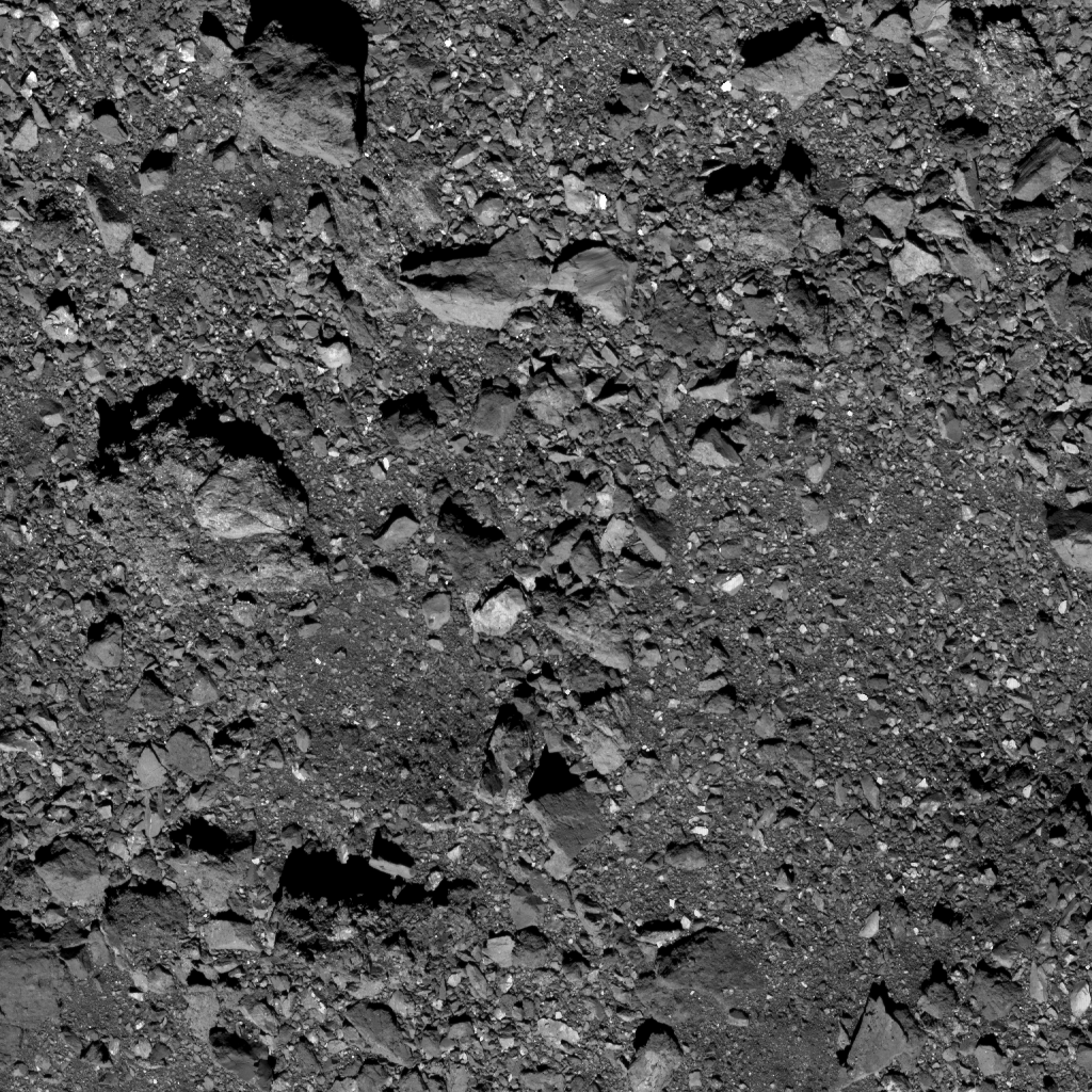 This is the highest-resolution image captured of candidate sample site Kingfisher as of October 19. Site Kingfisher is located near asteroid Bennu’s equator in the northern hemisphere. The site itself is visible in the lower right of the image, located in the middle of the relatively clear space. The image was taken by the PolyCam camera on NASA’s OSIRIS-REx spacecraft on October 19, from a distance of 0.6 miles (1 km). The field of view is 47 ft (14.4 m). For reference, the small crater is 9 ft (2.7 m) across, which is about the length of a dolphin. Image Credit: NASA/Goddard/University of Arizona