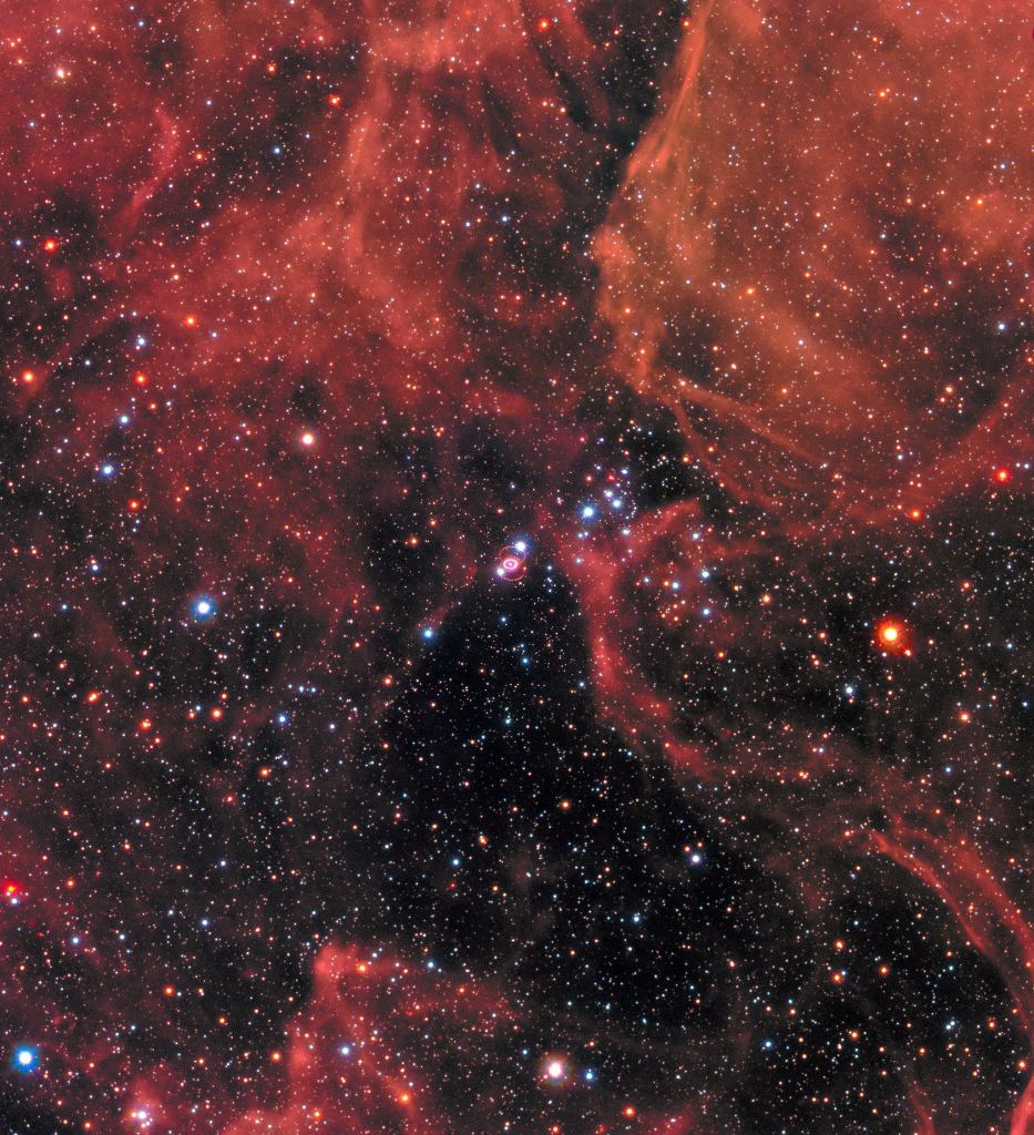 This image of the supernova remnant SN 1987A was taken by the NASA/ESA Hubble Space Telescope in January 2017 using its Wide Field Camera 3 (WFC3). Since its launch in 1990 Hubble has observed the expanding dust cloud of SN 1987A several times has helped astronomers get a better understanding of these cosmic explosions. Supernova 1987A is located in the centre of the image amidst a backdrop of stars. The bright ring around the central region of the exploded star is material ejected by the star about 20 000 years before the actual explosion took place. The supernova is surrounded by gaseous clouds. The clouds’ red colour represents the glow of hydrogen gas. Image Credit: NASA, ESA, and R. Kirshner (Harvard-Smithsonian Center for Astrophysics and Gordon and Betty Moore Foundation) and P. Challis (Harvard-Smithsonian Center for Astrophysics)