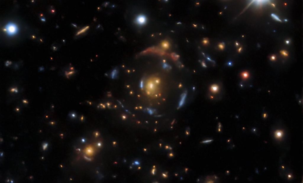 Four different galaxies being gravitationally lensed by the same foreground galaxy.