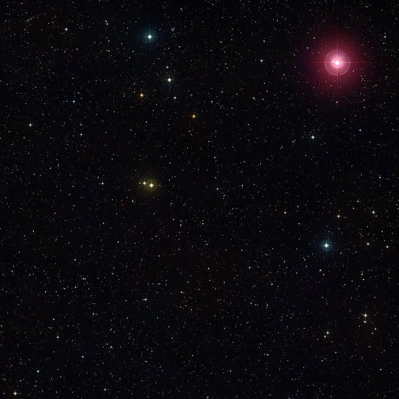 Variable star Mira (upper right red star) varies in brightness over a period of more than 100 days. It's a pulsating red giant, and will eventually become a planetary nebula. Courtesy ESO and the Digital Sky Survey.