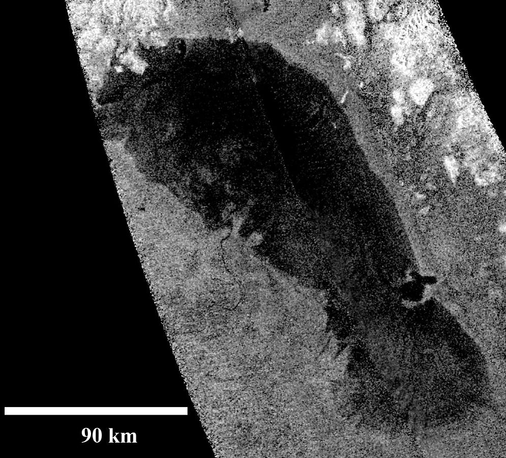 A Cassini radar image of Ontario Lacus (Lake Ontario) the first confirmed hydrocarbon on Titan. Ontario Lacus is at the moon's south polar region. Image Credit: By NASA/JPL-Caltech - http://photojournal.jpl.nasa.gov/catalog/PIA13172, Public Domain, https://commons.wikimedia.org/w/index.php?curid=10976062