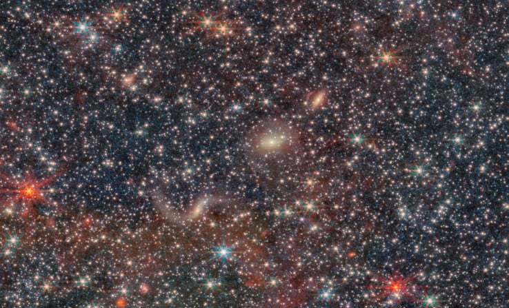 Zooming into almost any part of the image reveals distant galaxies. In this portion, a trio of galaxies lines up diagonally. Image Credit: ESA/Webb, NASA & CSA, M. Meixner