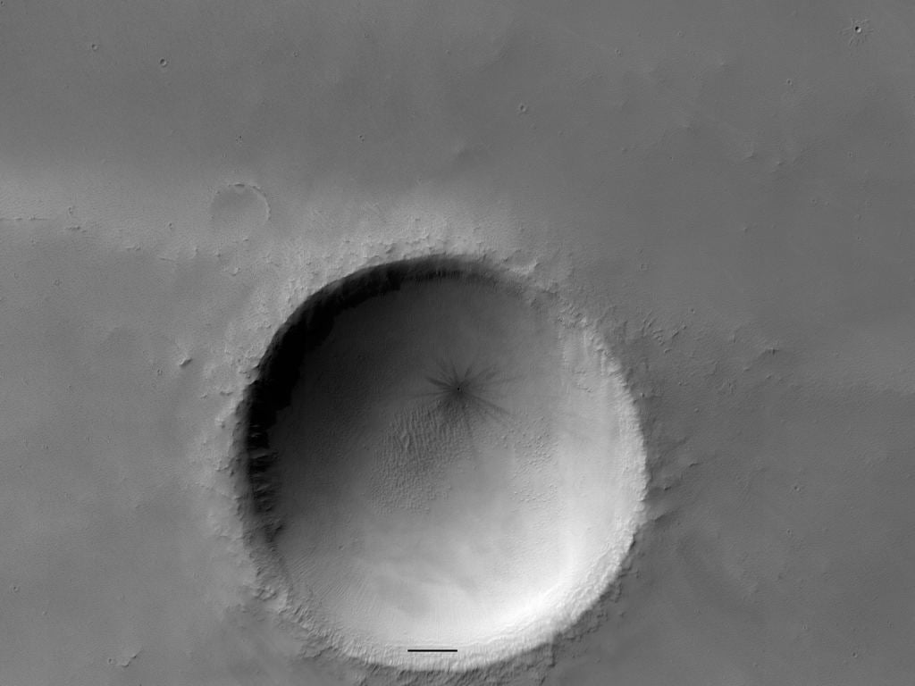 This crater has a tiny crater within it. The image is from between March 2017 and June 2019. Image Credit: NASA/JPL/UofArizona