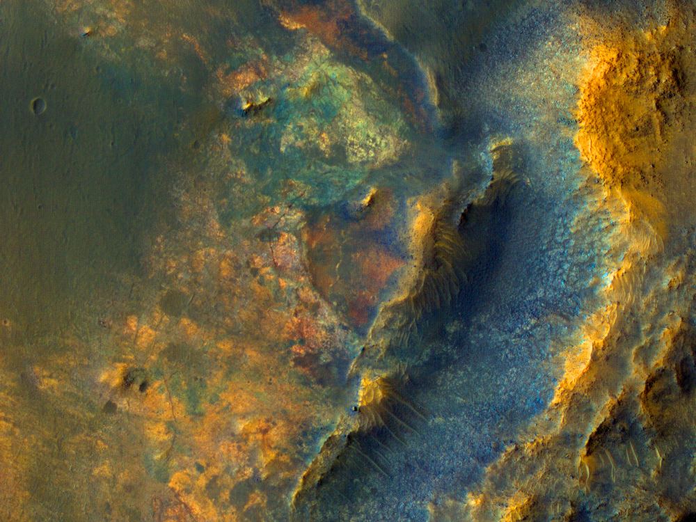 The diverse landforms and colours in the image make the area a tantalizing place for Perseverance to explore. While the HiPOD post talks about this as a potential landing spot for Mars Sample Return, there are no plans to land here. Image Credit: NASA/JPL/UArizona