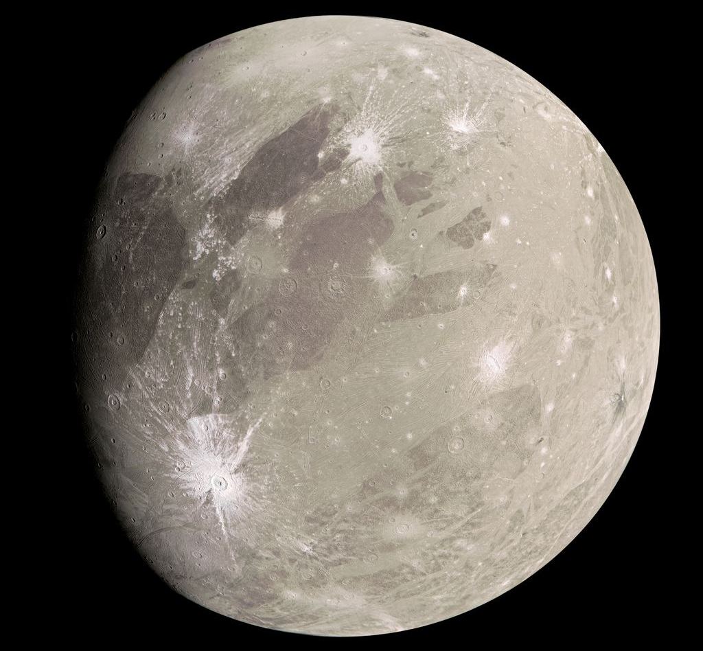 Juno captured this image of Ganymede in July 2022. The moon's impact craters are easily visible, including the crater Tros, which is prominent below the center at left. Image Credit: NASA/JPL-Caltech/SwRI/MSSS/Kevin M. Gill