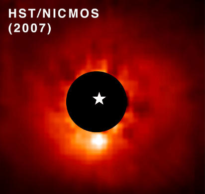 This Hubble image shows the star AB Aurigae and the exoplanet AB Aurigae b. Hubble's coronagraph (black circle) blocked out the light from the star, making the exoplanet brighter. The exoplanet is the bright patch below the coronagraph. The white star symbol marks AB Aurigae's position. Image Credit: NASA, ESA, T. Currie (Subaru Telescope, Eureka Scientific Inc.), A. Pagan (STScI); CC BY 4.0