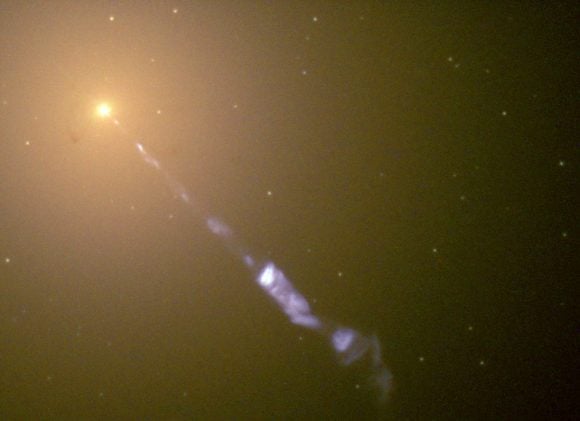 Image taken by the Hubble Space Telescope of a 5000-light-year-long jet ejected from the active galaxy M87. The blue synchrotron radiation contrasts with the yellow starlight from the host galaxy. Credit: NASA/The Hubble Heritage Team (STScI/AURA)