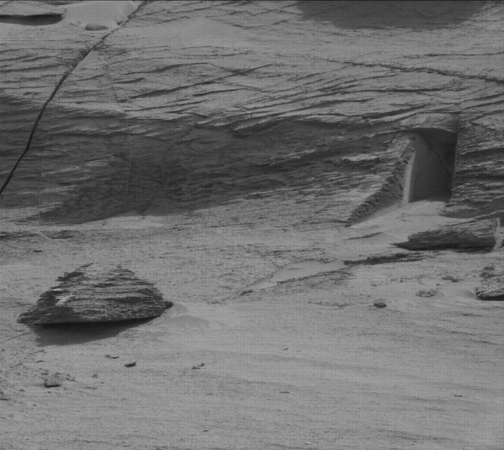 A Mastcam image from the Mars Curiosity rover captures what looks like a doorway into a rock ledge. It was formed when layered rock cracked and eroded away. Courtesy NASA Mars Curiosity Rover team.