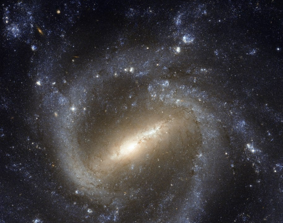 The barred spiral NGC 1073 is different from the Milky Way. It's bar is larger and the arms are less well-defined and not as symmetrical. Image Credit: By NASA & ESA, CC BY 4.0, https://commons.wikimedia.org/w/index.php?curid=20190213