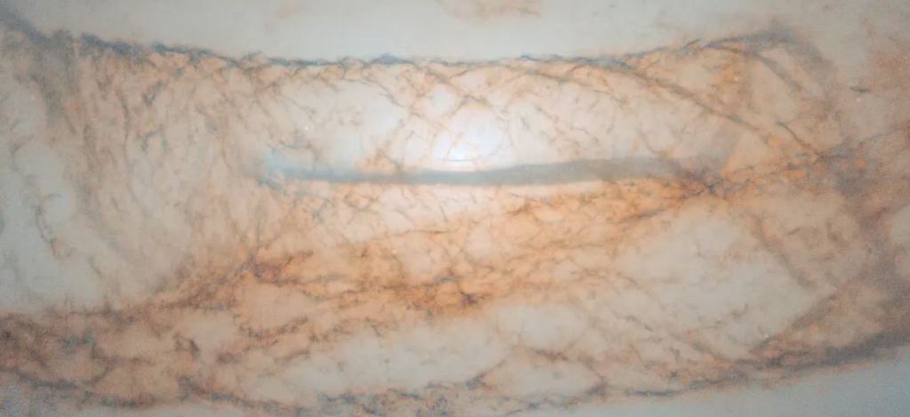 Astronomers think that NGC 4753 is the result of a merger with a dwarf galaxy over one billion years ago. The dwarf galaxy was gas-rich, and NGC 4753's distinct dust rings probably accreted from the merger. NGC 4753's powerful gravity then shaped the gas into the complex shapes we see in this image. Image Credit: ESA/Hubble & NASA, L. Kelsey