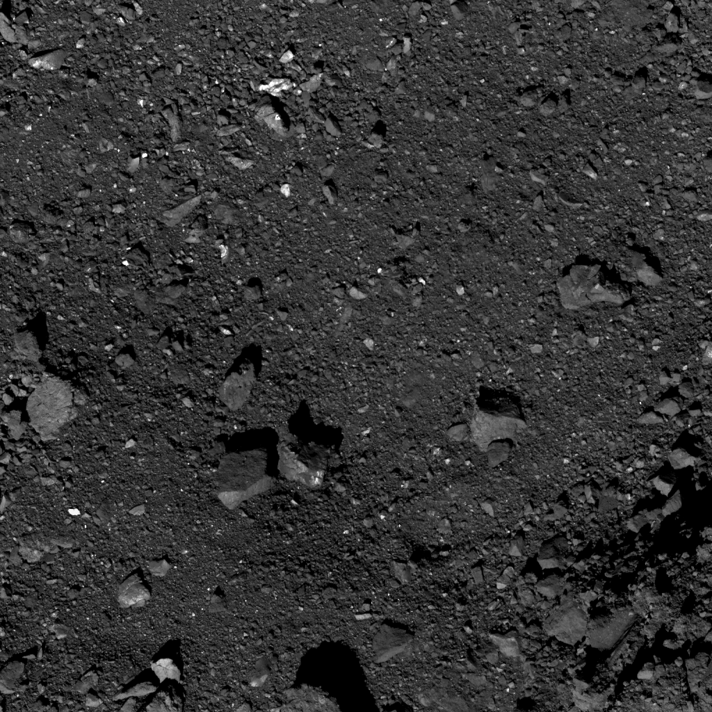 This is the highest-resolution image captured of candidate sample site Nightingale as of October 26. Site Nightingale is located near asteroid Bennu’s north pole. The crater’s center is visible in the top center of the image, which contains an accumulation of smaller rocks. The image was taken by the PolyCam camera on NASA’s OSIRIS-REx spacecraft on October 26, from a distance of 0.6 miles (1 km). The field of view is 47 ft (14.4 m). For reference, the light-colored boulder (far left center) is 5 ft (1.4 m) long, which is about the length of a bicycle. Image Credit: NASA/Goddard/University of Arizona
