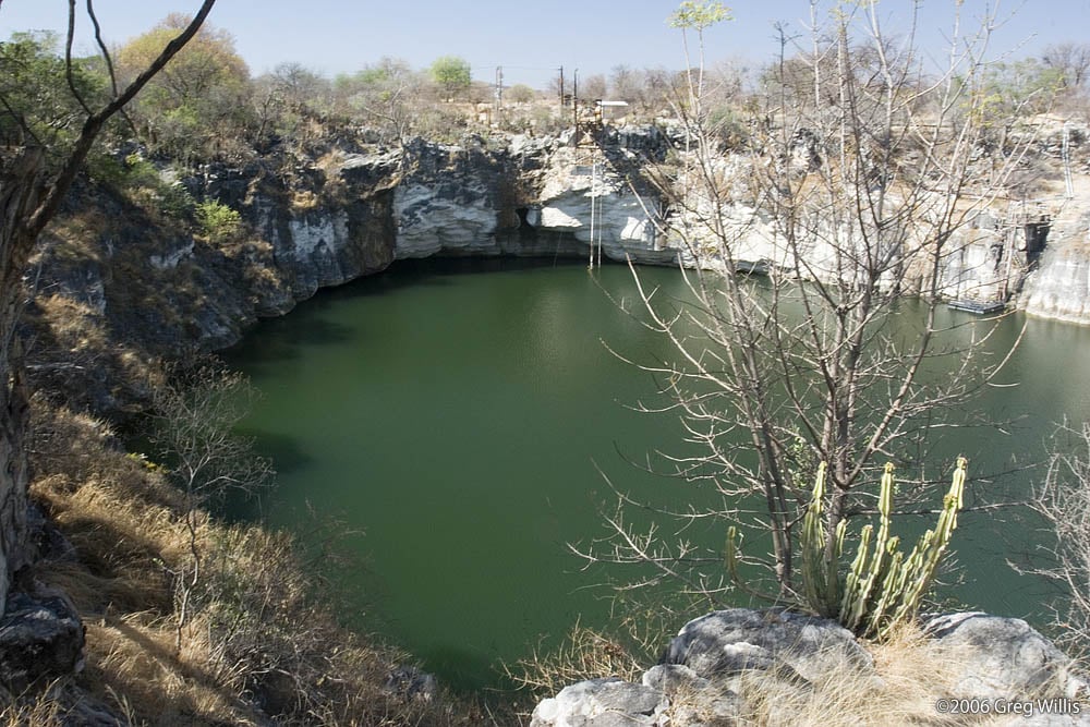 Karst lakes like Otjikoto Lake in Namibia form when rainwater dissolves the limestone bedrock. Scientists think a similar process with hydrocarbons instead of water forms the lakes on Titan's eastern side. Image Credit: By greg willis - http://greg-willis.com/gallery/Travel/Namibia06/AloegroveLodge/c-1689.jpg.html, CC BY-SA 2.5, https://commons.wikimedia.org/w/index.php?curid=7161426