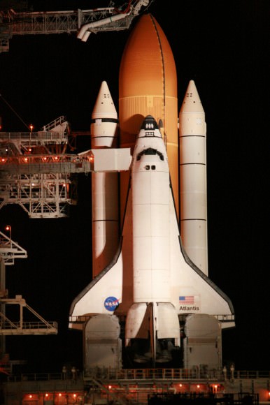 Close up of Space Shuttle Atlantis and crew walk out arm and platform at 195 ft level of pad 39 A. Close out crew assists crew into their seats. Thereafter the orbiter hatch is closed for the 11 day mission to the ISS. The arm swings away a few minutes prior to launch. Credit: Ken Kremer