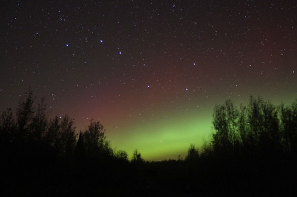 A classic quiet start to Tuesday night's northern lights - a low green arc below the Big Dipper topped by a very faint red border. Credit: Bob King