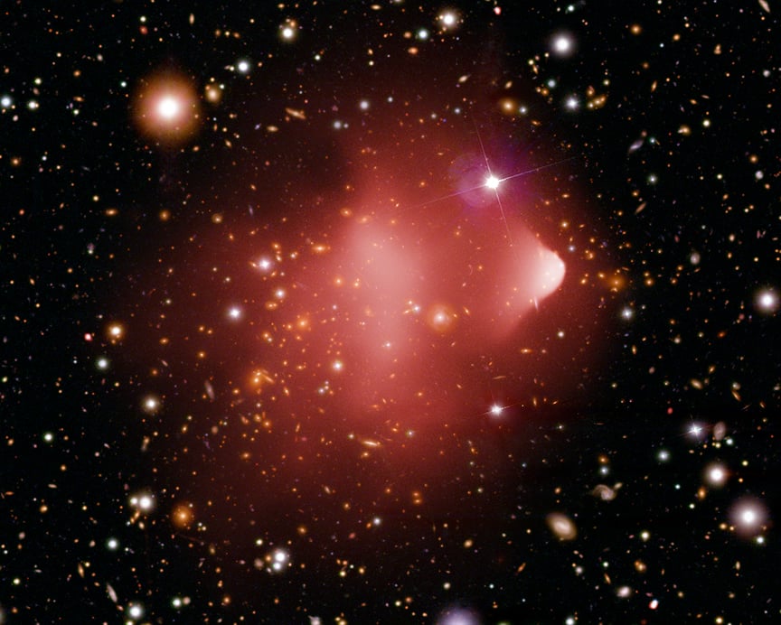 The Bullet Cluster is another of several gigantic galaxy clusters challenging the Lambda-cold dark matter theory of struc ture formation in the early Universe. Credit: X-ray: NASA/CXC/CfA/M.Markevitch et al.; Optical: NASA/STScI; Magellan/U.Arizona/D.Clowe et al.