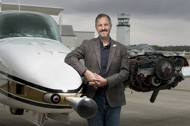 Dan Cziczo stands in front of NASA's ER-2 High-Altitude Science Aircraft. Image Credit: Purdue University photo/John Underwood
