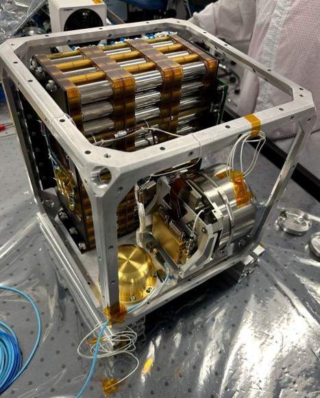 Seen here during assembly in November 2023, Farside Seismic Suite’s inner cube houses the NASA payload’s large battery (at rear) and its two seismometers. The gold, puck-shaped device holds the Short Period sensor, while the silver enclosure contains the Very Broadband seismometer. These devices will detect moonquakes on the Moon's far side. Credit: NASA/JPL-Caltech