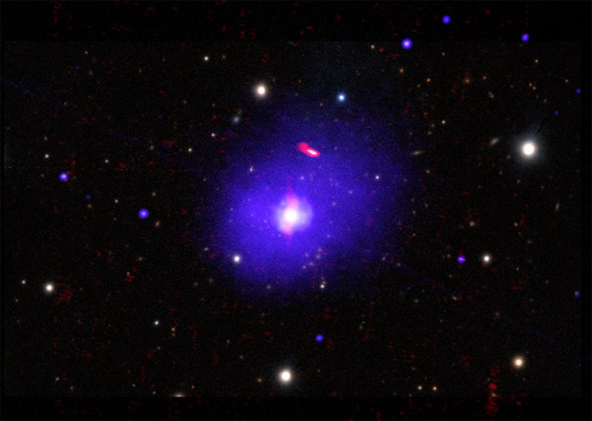 This composite image of H1821+643 contains X-rays from Chandra (blue) that have been combined with radio data from NSF's Karl G. Jansky Very Large Array (red) and an optical image from the PanSTARRS telescope on Hawaii (white and yellow). The researchers used nearly a week's worth of Chandra observing time, taken over two decades ago, to obtain this latest result. The supermassive black hole is located in the bright dot in the center of the radio and X-ray emission.