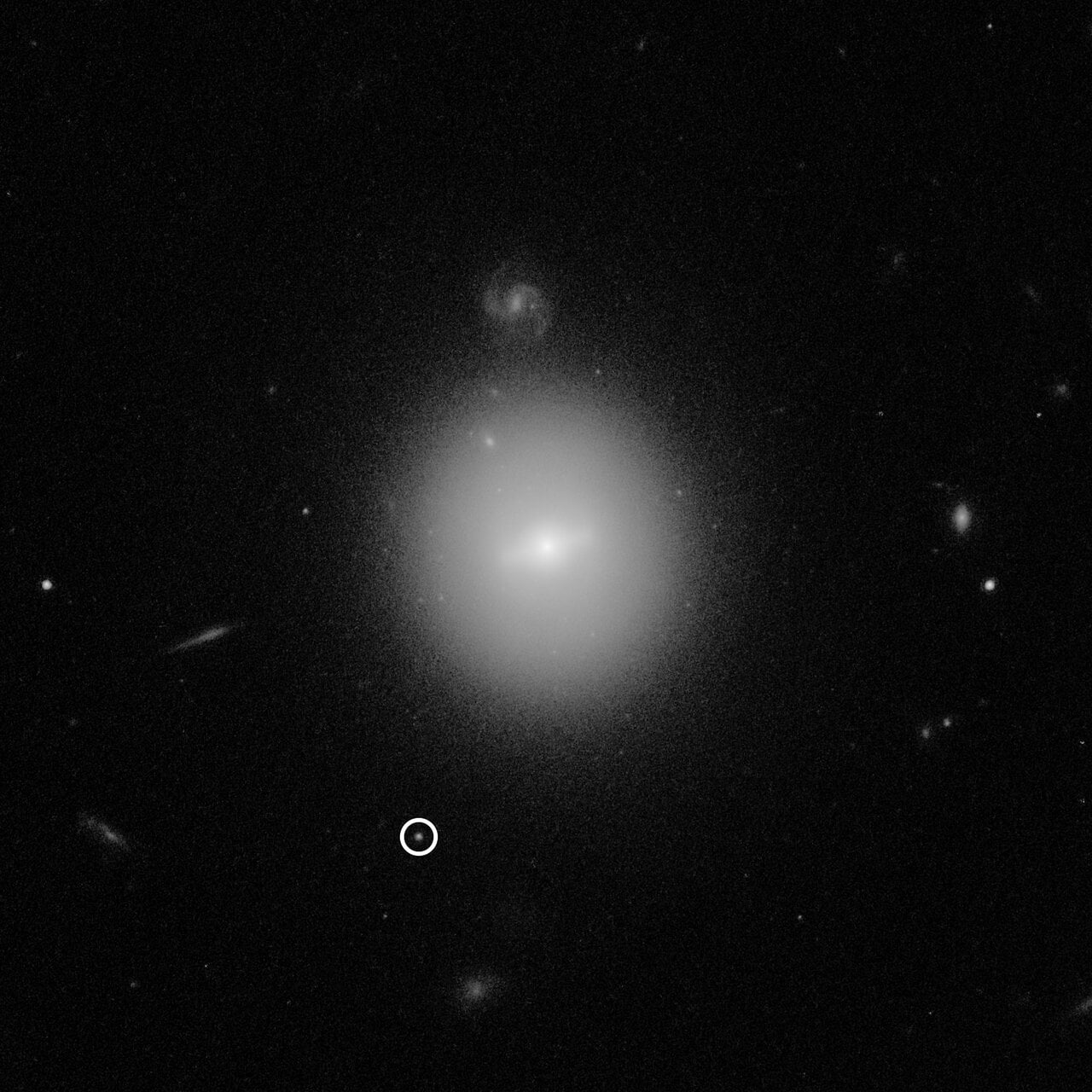 This Hubble Space Telescope image identified the location of an intermediate-mass black hole named J 2150 (3XMM J215022.4 055108), weighing over 50,000 times the mass of our Sun. The black hole is indicated by the white circle. This photo was taken with Hubble's Advanced Camera for Surveys. Image Credit: NASA, ESA, and D. Lin (University of New Hampshire)