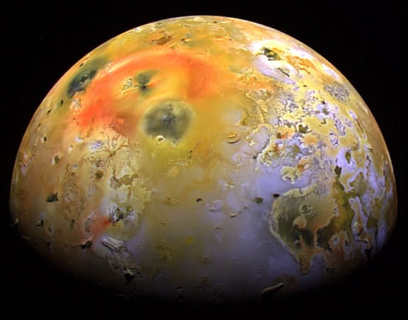 Io, a moon of Jupiter. The colors in this image have been enhanced to better show differences. Sulfur dioxide frost appears in white and grey, and other types of sulfur are in yellow and brown. Recent volcanic activity is marked by red and black blotches. Credit: NASA