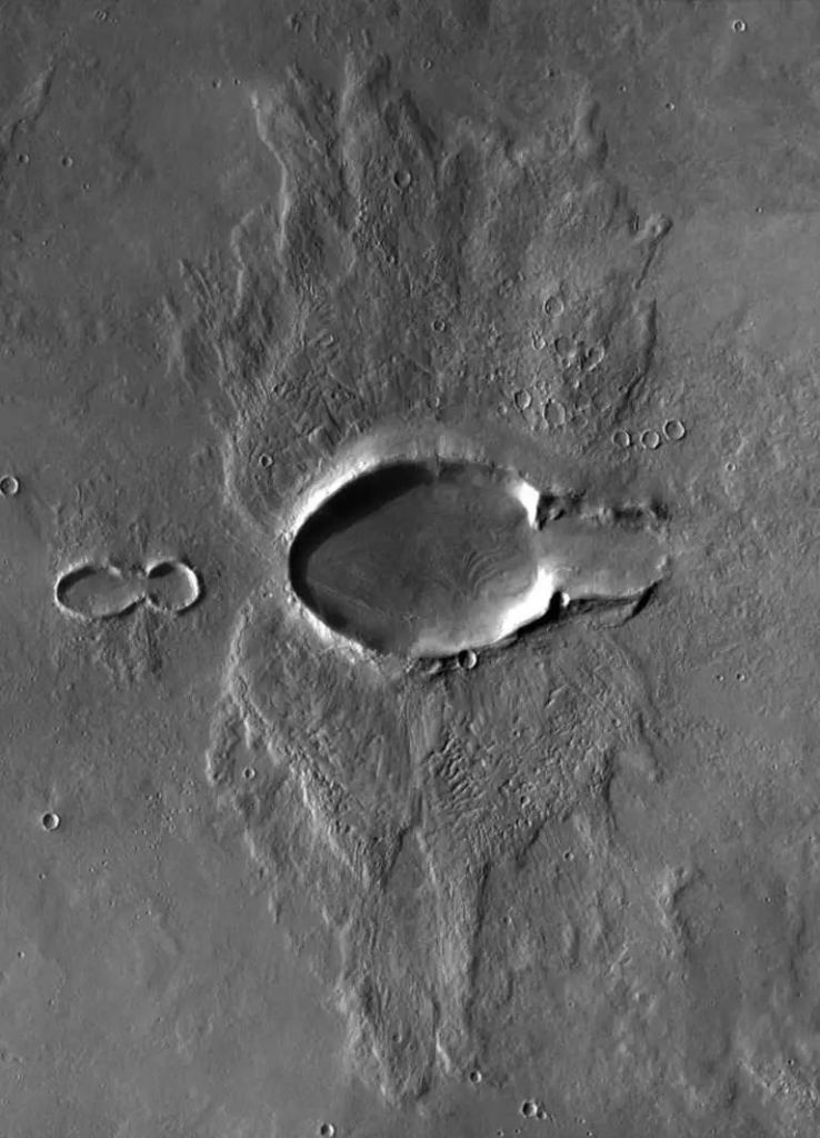 This oblique impact crater has an odd butterfly ejecta shape. It's 15 kilometres long and is north of Acheron Fossae on Mars. This image is a mosaic of three images captured by the THEMIS instrument on Mars Odyssey. Image Credit: NASA / JPL / UA / mosaic by Emily Lakdawalla
