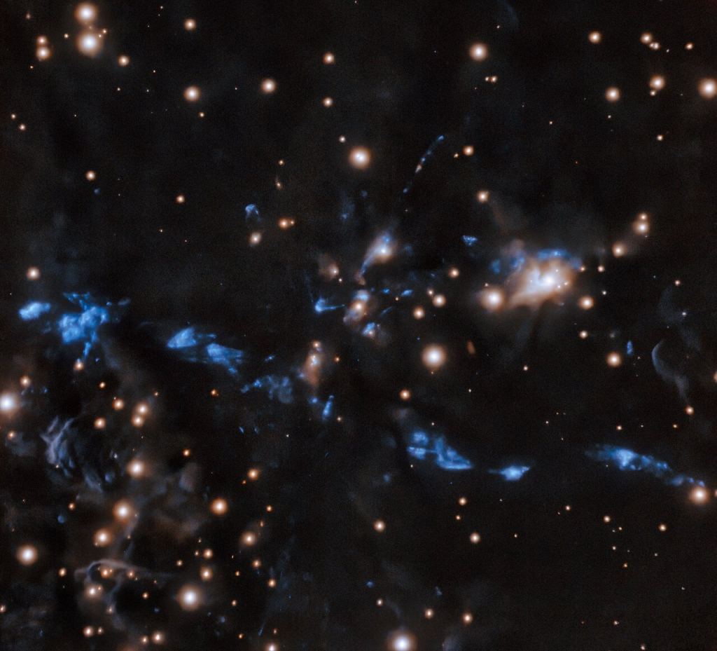 This image of the knotted young stellar jet MHO 1502 was also captured by the international Gemini Observatory, a Program of NSF's NOIRLab. The stellar jet is embedded in an area of star formation known as an HII region. A chain of knots makes up this bipolar jet, suggesting that the binary star responsible for it emits material intermittently. The Gemini South telescope captured these crystal clear images using its adaptive optics system, which helps astronomers counteract the blurring effects of atmospheric turbulence. Image Credit: International Gemini Observatory/NOIRLab/NSF/AURA