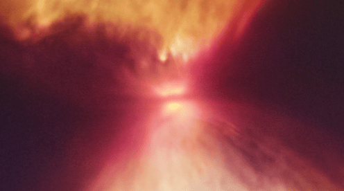 The protostar L1527 sits between the two lobes of the hourglass. It can't be seen, and doesn't emit optical light. But the darker horizontal line in the very middle is the circumstellar disk, and the protostar sits right inside. Image Credit: NASA, ESA, CSA, and STScI, J. DePasquale (STScI), CC BY-SA 3.0 IGO