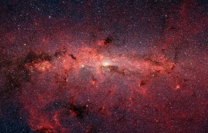 This dazzling infrared image from NASA's Spitzer Space Telescope shows hundreds of thousands of stars crowded into the swirling core of our spiral Milky Way galaxy. Infrared light can penetrate the dense clouds of gas and dust and reveal the richness of the stellar population there. Credit: NASA/JPL-Caltech