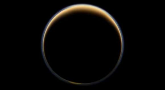ASA's Cassini spacecraft looks toward the night side of Saturn's largest moon and sees sunlight scattering through the periphery of Titan's atmosphere and forming a ring of color. Credit: NASA/JPL-Caltech/Space Science Institute