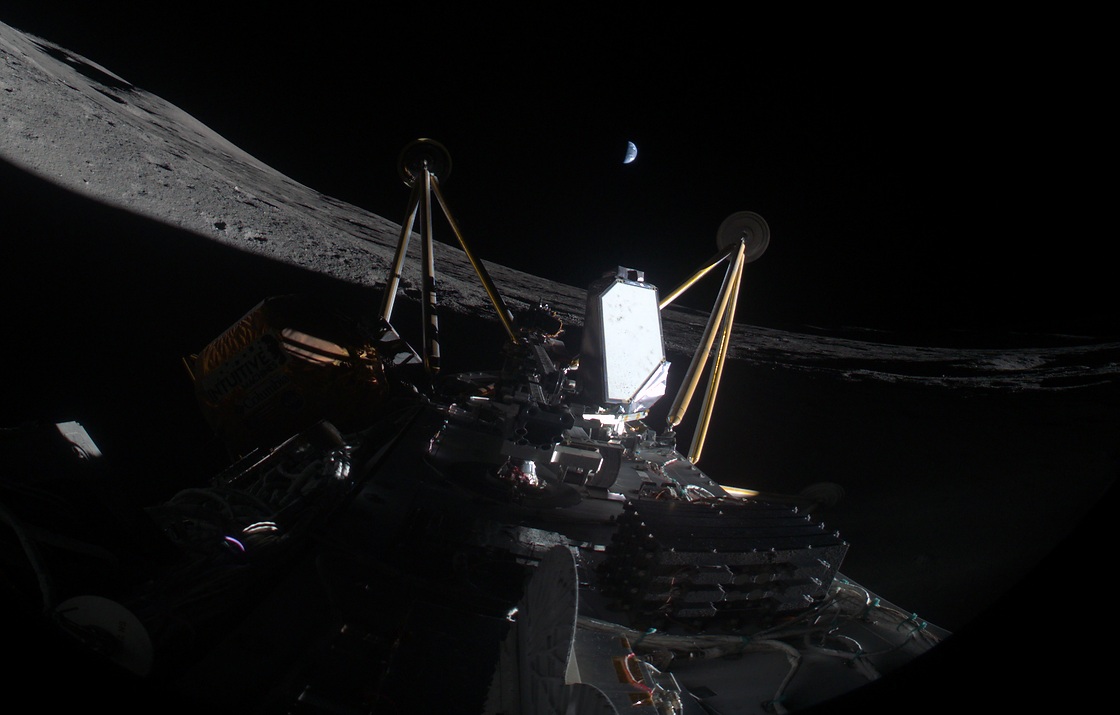 Image of the IM-2 mission laying on its side in a lunar crater with Earth in the distance.Credit: Intuitive Machines