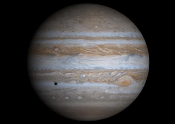 A true-color image of Jupiter taken by the Cassini spacecraft. The Galilean moon Europa casts a shadow on the planet's cloud tops. Credit: NASA/JPL/University of Arizona