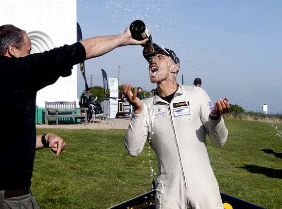 The Swiss pilot Yves Rossy is sprayed with champagne near Dover after flying with jet-propelled wings across the Channel from France  (Adrian Dennis/AFP/Getty) 