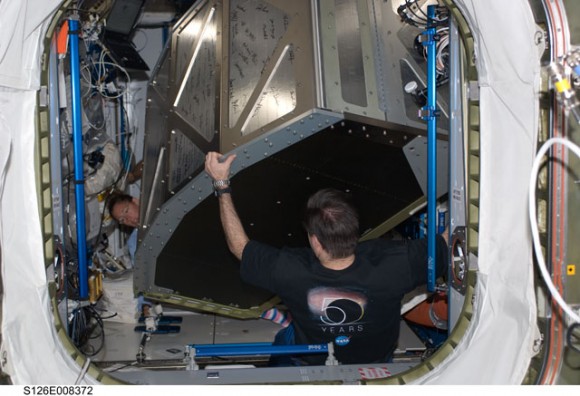 Astronauts install a new component. Credit: NASA