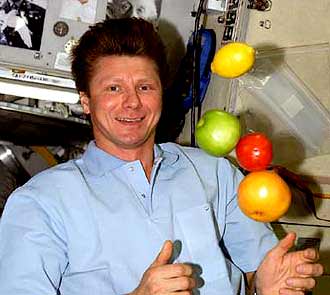 Padalka on the ISS:  Sharing food is good in space.  Credit: NASA