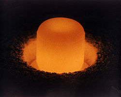Pellet of Pu-238.  RTGs are constructed using marshmallow-sized pellets of Pu-238. As it decays, interactions between the alpha particles and the shielding material produce heat that can be converted into electricity.