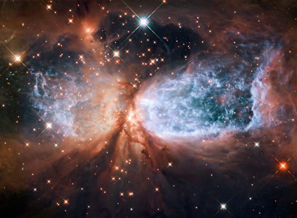 This image from the NASA/ESA Hubble Space Telescope shows Sh 2-106, or S106 for short. This is a compact star forming region in the constellation Cygnus (The Swan). A newly-formed star called S106 IR is shrouded in dust at the centre of the image, and is responsible for the surrounding gas cloud’s hourglass-like shape and the turbulence visible within. Light from glowing hydrogen is coloured blue in this image. Credit: NASA/ESA