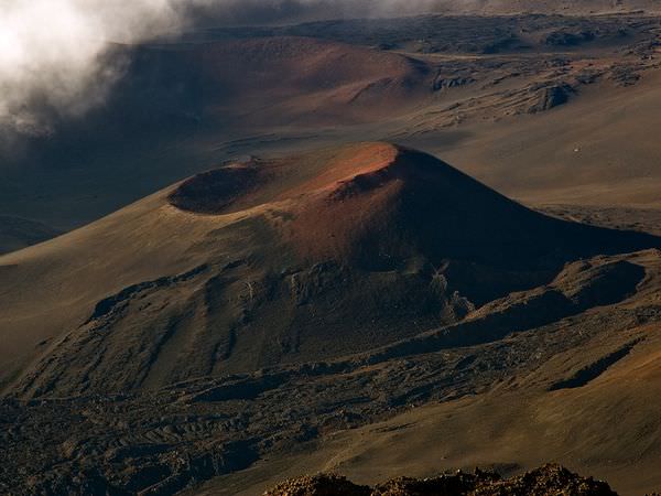 Haleakala, a giant shield volcano, forms the eastern bulwark of the island of Maui. In Earth's deep past, periods of increased volcanism would've helped the Earth cool, like a radiation releasing steam. Credit: National Geographic/Cathy Roberts