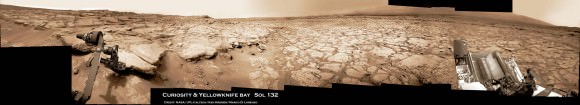 Photo mosaic shows NASA’s Curiosity Mars rover in action reaching out to investigate rocks at a location called Yellowknife Bay on Sol 132, Dec 19, 2012 in search of first drilling target. The view is reminiscent of a dried up shoreline. Curiosity’s navigation camera captured the scene surrounding the rover with the arm deployed and the APXS and MAHLI science instruments on tool turret collecting microscopic imaging and X-ray spectroscopic data. The mosaic is colorized. See the full 360 degree panoramic and black & white versions below. Credit: NASA/JPL-Caltech/Ken Kremer/Marco Di Lorenzo