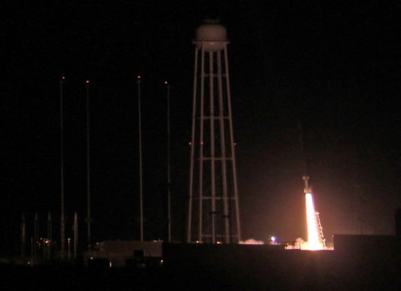 Ignition of NASA Black Brant XII suborbital rocket following night time launch at 11:05 p.m. EDT on June 5, 2013 from the NASA Wallops Flight Facility at the eastern Virginia shoreline. The launch pad sits in front of the Antares rocket Launch Complex 0A dominated by the huge water tower.  The rocket carried the CIBER astronomy payload to an altitude of approximately 358 miles above the Atlantic Ocean to study when the first stars and galaxies formed in the universe and how brightly they burned their nuclear fuel.  Credit: Ken Kremer- kenkremer.com