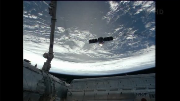 Cygnus commercial cargo craft rapidly departed the ISS this morning (Oct. 22) after release from the Canadarm2 robotic arm. Station modules visible at bottom. Credit: NASA TV