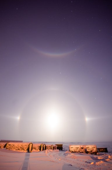 The Full Moon, a "Moon Dog" halo, and a rare parhelic (or do you say Palunic?) arc as seen from North Slope Borough County, Alaska. Credit-Jason Ahrns. 