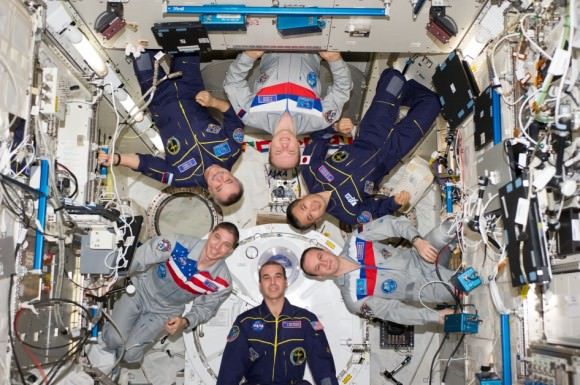 Expedition 38 crew members proudly sport their national flags in this March 2014 picture from the International Space Station. Pictured (clockwise from top center) are Russian cosmonaut Oleg Kotov, commander; Japan Aerospace Exploration Agency astronaut Koichi Wakata, Russian cosmonaut Sergey Ryazanskiy, NASA astronauts Rick Mastracchio and Mike Hopkins, and Russian cosmonaut Mikhail Tyurin, all flight engineers. Credit: NASA