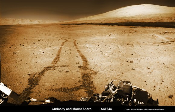 NASA’s Curiosity rover trundles towards Mount Sharp (right) across the alien terrain of Mars - our Solar Systems most Earth-like planet - and leaves behind dramatic wheel tracks in her wake, with Gale crater rim visible in the distance at left. Curiosity captured this photo mosaic of her wheel tracks, mountain and crater rim on Sol 644 after departing ‘Kimberley’ drill site in mid-May 2014. Navcam raw images were stitched and colorized and contrast enhanced to bring out detail. Credit: NASA/JPL-Caltech/Marco Di Lorenzo/Ken Kremer – kenkremer.com